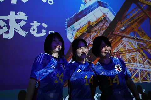 Fans pose for a photo before Japan's World Cup Group F soccer match against Tunisia in Mexico, during a public viewing event in Tokyo, Sunday, June 21, 2026.