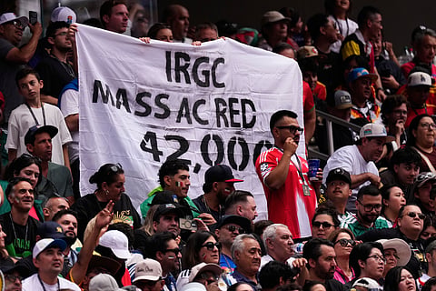 Fans hold up a banner during the World Cup Group G soccer match between Belgium and Iran in Inglewood, Calif., near Los Angeles, Sunday