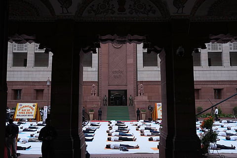 Participants perform yoga during a session on the occasion of the International Day of Yoga at the Parliament House complex, in New Delhi.