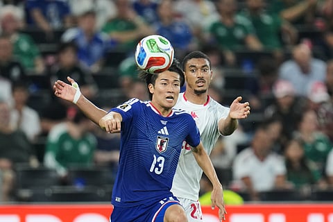 Japan's Keito Nakamura (13) and Tunisia's Yan Valery view the ball during the World Cup Group F soccer match in Guadalupe, near Monterrey, Mexico, Saturday, June 20, 2026.