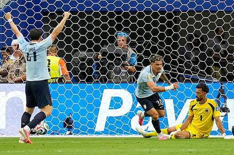 Uruguay's Maxi Araujo, centre, reacts after scoring his team's first goal during the World Cup Group H soccer match between Uruguay and Cape Verde in Miami Garden