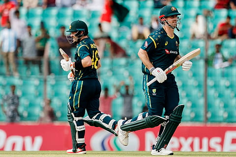 Australia's captain Mitchell Marsh, right, and Josh Inglis run between the wickets to score during the third T20 international cricket match between Australia and Bangladesh, in Chattogram, Bangladesh.