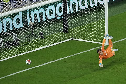 Tunisia goalkeeper Aymen Dahmen fails to stop Japan's Ayase Ueda from scoring his team's second goal during a World Cup Group F soccer match in Guadalupe, near Monterrey, Mexico, Saturday, June 20, 2026.