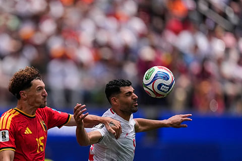 Belgium's Thomas Meunier, left, and Iran's Mehdi Taremi view the ball during the World Cup Group G soccer match in Inglewood, Calif., near Los Angeles, Sunday, June 21, 2026