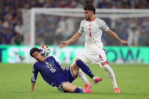 Japan's Daichi Kamada (15) gets hit by the ball after battling with Tunisia's Omar Rekik (4) during the World Cup Group F soccer match between Tunisia and Japan in Guadalupe, near Monterrey, Mexico, Saturday, June 20, 2026.