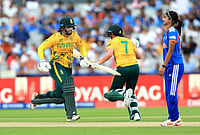 | Photo: Nigel French/PA via AP : South Africa's Chloe Tryon (left) and Marizanne Kapp score the winning runs as India players look on during the ICC Women's T20 World Cup match between India and South Africa, at Emirates Old Trafford, Manchester, England.