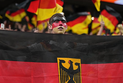 A German fan holds national flag before the World Cup Group E soccer match between Germany and Curacao in Houston, Sunday, June 14, 2026. 