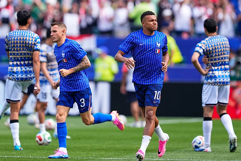 France's Kylian Mbappe (10) and teammate Lucas Digne (3) warm up ahead of the World Cup Group I soccer match - AP/Petr David Josek