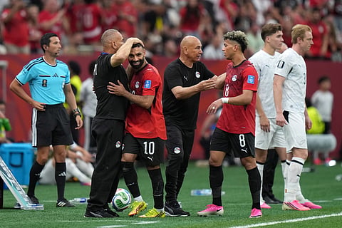 Egypt's Mohamed Salah (10) is congratulated on his goal by coaching staff as head coach Hossam Hassan confers with teammate Emam Ashour (8) during the second half of the World Cup Group G soccer match in Vancouver, British Columbia, Sunday, June 21, 2026