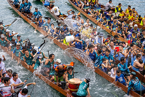 Competitors splash water on each other during the Aberdeen Dragon Boat Race to celebrate the Dragon Boat Festival in Hong Kong.