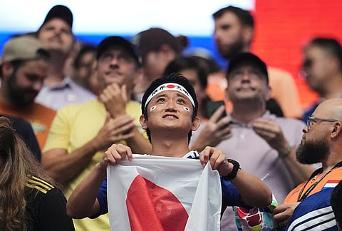 A fan of Japan holds his country's flag prior to the World Cup Group F soccer match between the Netherlands and Japan in Arlington, Texas, near Dallas, Sunday, June 14, 2026. 