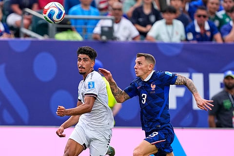 Iraq's Ahmed Qasim (11) and France's Lucas Digne (3) battle for the ball during the World Cup Group I soccer match