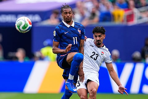 France's Michael Olise (11) and Iraq's Merchas Doski (23) battle