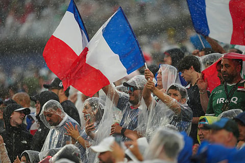 Fans wave French flags during the World Cup Group I soccer match between France and Iraq in Philadelphia.