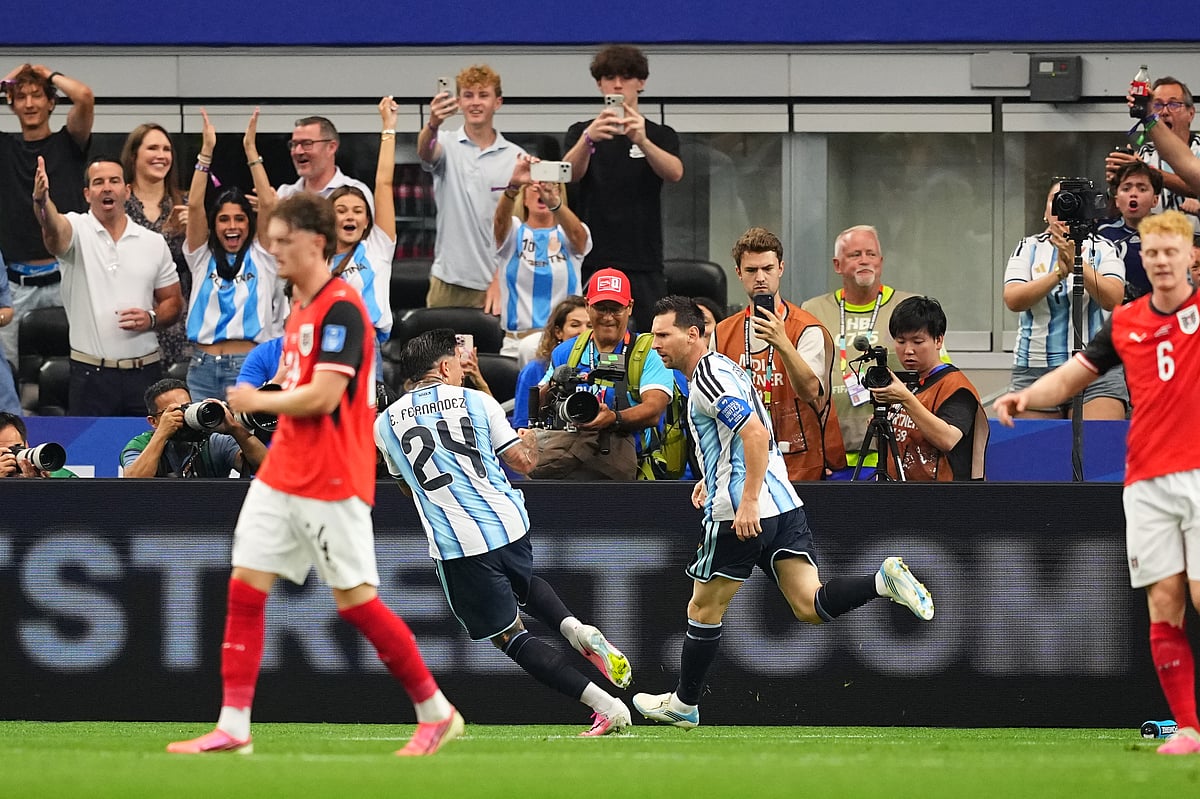 Argentina's Lionel Messi, right, runs with the ball pursued by Austria's Xaver Schlager during the World Cup Group J soccer match - AP