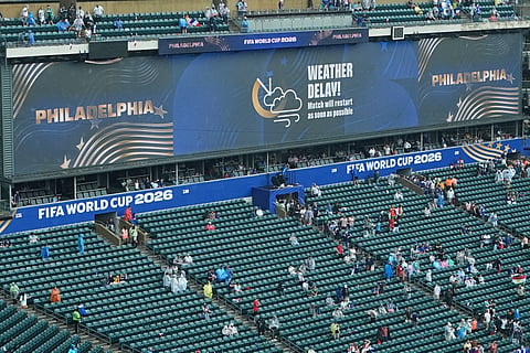 A sign advising fans of a weather delay is displayed during the World Cup Group I soccer match between France and Iraq