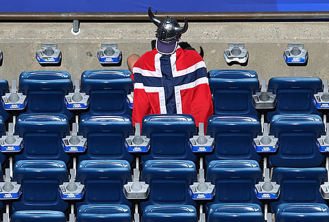 A Norway fan dons a viking helmet nd flag waiting for the start of the World Cup Group I soccer match between Iraq and Norway in Foxborough, Mass., near Boston, Tuesday, June 16, 2026. 