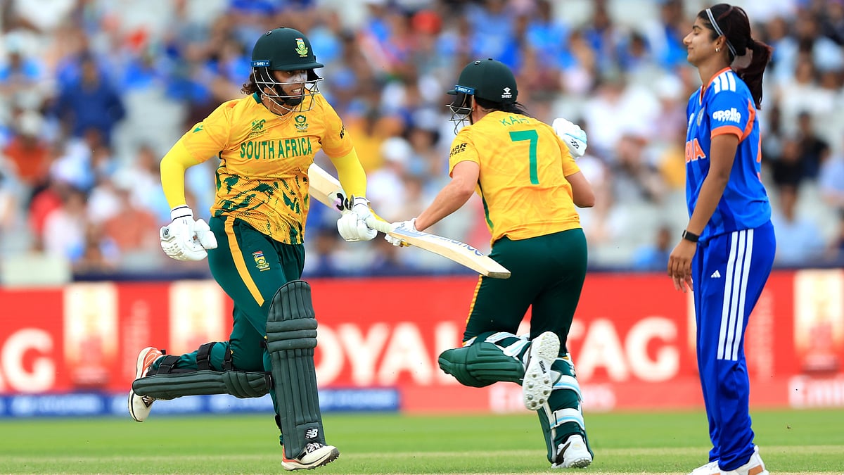 South Africa's Chloe Tryon (left) and Marizanne Kapp score the winning runs as India players look on during the ICC Women's T20 World Cup match between India and South Africa, at Emirates Old Trafford, Manchester, England, Sunday June 21, 2026 - (Nigel French/PA via AP)