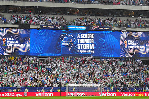 Fans are warned to seek shelter from approaching thunder storm during the World Cup Group I soccer match between France and Iraq in Philadelphia, Monday, June 22, 2026