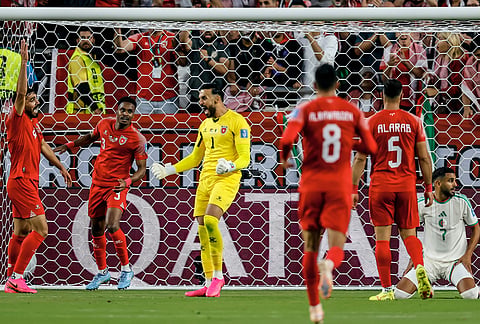 Jordan goalkeeper Yazeed Abulaila (1) celebrates a successful defense of a shot on goal with teammates during the World Cup Group J soccer match between Jordan and Algeria in Santa Clara, Calif., near San Francisco.