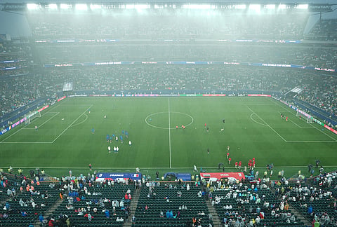 Players warm up after a weather delay during the World Cup Group I soccer match between France and Iraq in Philadelphia.