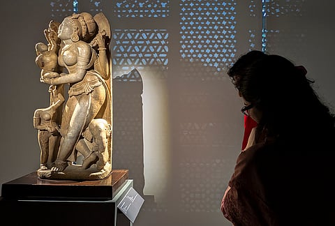 Visitors look at artworks during the "One Mother, Many Mother Tongues" exhibition, at Humayun's Tomb museum in New Delhi. 