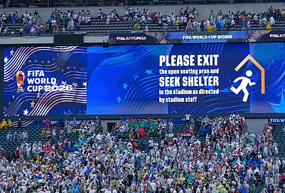 | Photo: AP/Petr David Josek : A sign is shown advising fans to exit seating as a severe weather storm hits during the World Cup Group I soccer match between France and Iraq in Philadelphia.