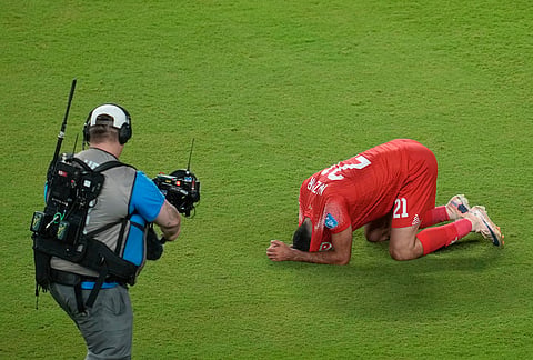 A camera operator captures images as Jordan's Nizar Alrashdan (21) reacts following the World Cup Group J soccer match between Jordan and Algeria in Santa Clara, California, near San Francisco.