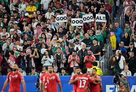 Spectators react after Jordan's Nizar Alrashdan scored the opening goal during the World Cup Group J soccer match between Jordan and Algeria in Santa Clara, Calif., near San Francisco.