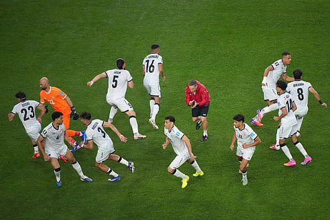 Players fo Iraq warm up after a weather delay during the World Cup Group I soccer match between France and Iraq in Philadelphia, Monday, June 22, 2026