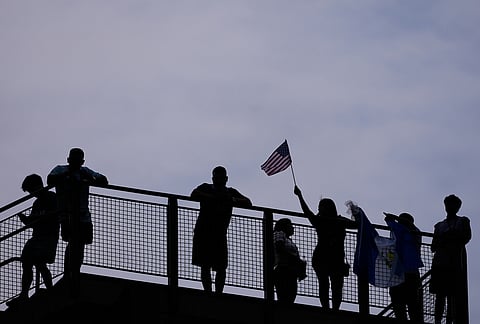 Fans wait for play to resume during the World Cup Group I soccer match between France and Iraq in Philadelphia.
