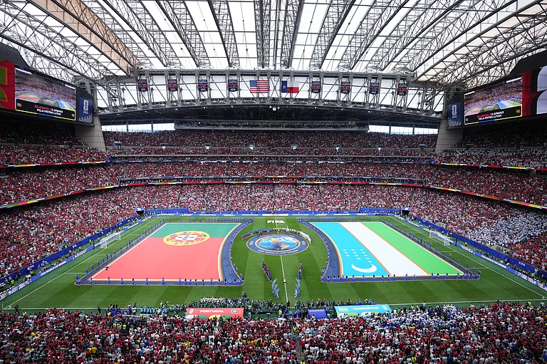 Flags for Portugal and Uzbekistan are displayed ahead of the World Cup Group K soccer match between Portugal and Uzbekistan. - AP/Karen Warren