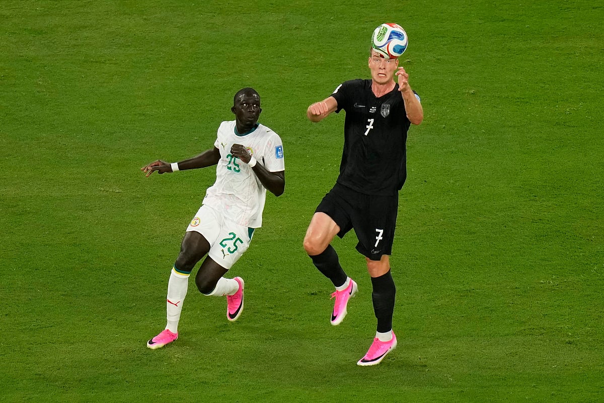 Senegal's El Hadji Malick Diouf (25), left, vies for the ball with Norway's Alexander Soerloth (7) during the World Cup Group I soccer match. - AP/Seth Wenig