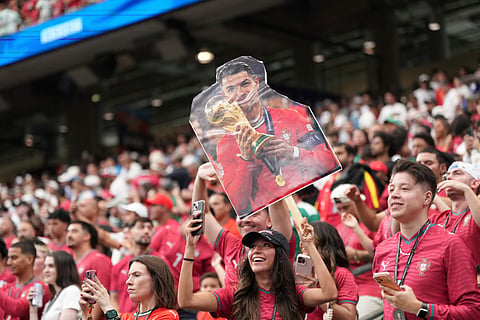 Fans of Portugal cheer before the kickoff the World Cup Group K soccer match between Portugal and Uzbekistan in Houston