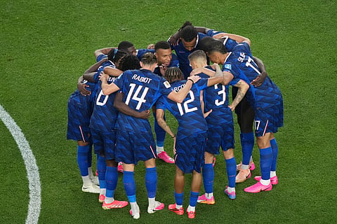 France's Kylian Mbappe, center, speaks with his teammates after a weather delay during the World Cup Group I soccer match between France and Iraq in Philadelphia, Monday, June 22, 2026
