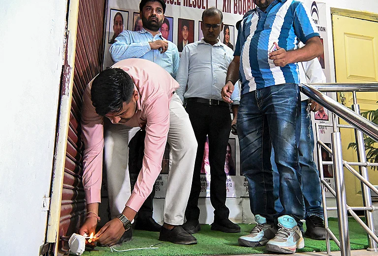 Authorities seal a coaching centre as part of a safety operation in the wake of the Lucknow fire incident, in Noida.
- | Photo: PTI