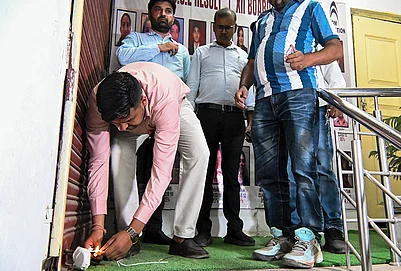 | Photo: PTI : Authorities seal a coaching centre as part of a safety operation in the wake of the Lucknow fire incident, in Noida.