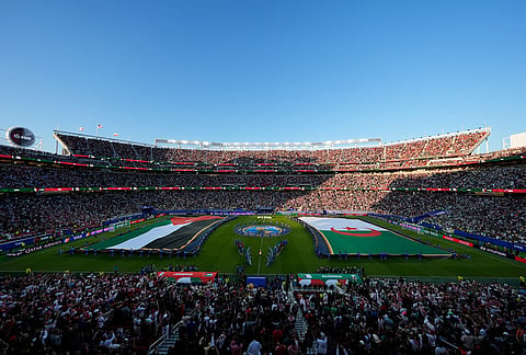 Flags are seen on the field during a pregame ceremony prior to the World Cup Group J soccer match between Jordan and Algeria in Santa Clara, Calif., near San Francisco.