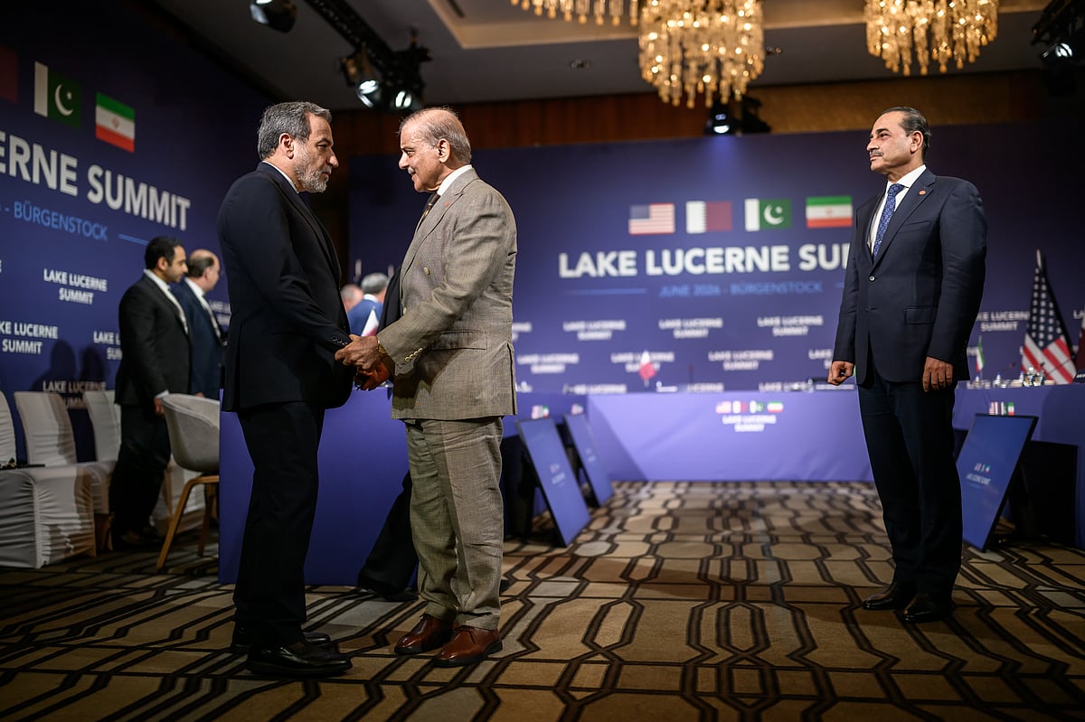 Iran's Foreign Minister Abbas Araghchi, left, shakes hands with Pakistan's Prime Minister Muhammad Shehbaz Sharif next to Pakistan's Chief of Army Staff Field Marshal Asim Munir, right, prior to a quadrilateral meeting between the United States, Iran, Pakistan and Qatar at the Burgenstock luxury hotel complex overlooking Lake Lucerne, Switzerland, Sunday June 21, 2026.  - (Fabrice Coffrini/Keystone via AP)