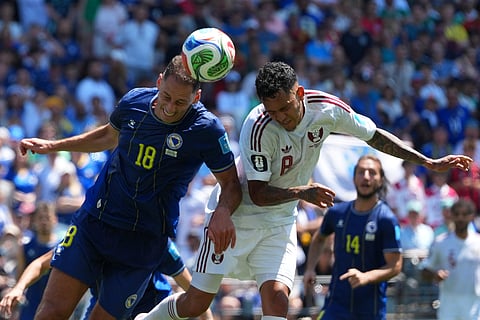 Qatar's Edmilson Junior (8), right, and Bosnia's Nikola Katic (18) jump for the ball during the World Cup Group B soccer match between Bosnia and Qatar in Seattle Wednesday, June 24, 2026.