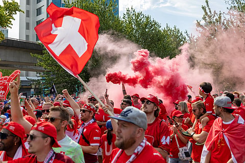 Switzerland fans march toward B.C. Place before the World Cup Group B soccer match between Switzerland and Canada in Vancouver, British Columbia, Wednesday, June 24, 2026.