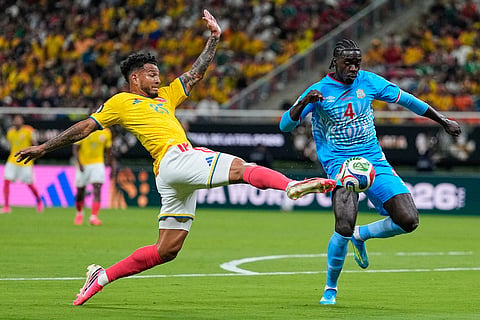 Colombia's Luis Suarez (25) and Congo's Axel Tuanzebe (4) battle for the ball during the World Cup Group K soccer match between Colombia and Congo in Zapopan, near Guadalajara, Mexico.