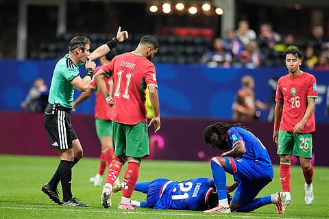 Haiti's Josue Casimir (21) is checked on by a teammate after a challenge during the World Cup Group C soccer match between Morocco and Haiti in Atlanta, Wednesday, June 24, 2026.
