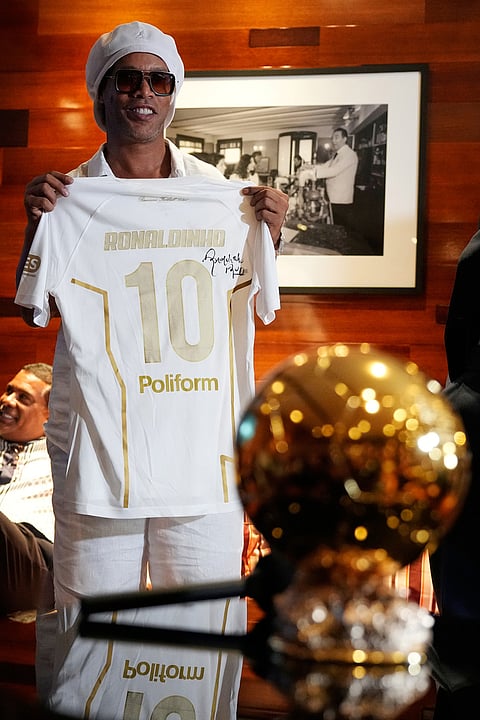 Brazilian football legend Ronaldinho holds up a Ravenna FC jersey at an event celebrating his recent signing with the Italian soccer club, at Cipriani Downtown Miami restaurant, in Miami.