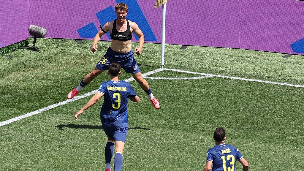 Bosnia's Ermin Mahmic (26), top, celebrates after scoring during the World Cup Group B soccer match between Bosnia and Qatar in Seattle. - Maddy Grassy/AP Photo