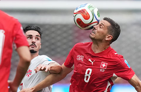 Switzerland's Remo Freuler (8) plays the ball in front of Canada's Stephen Eustaquio (7) during the World Cup Group B soccer match between Switzerland and Canada in Vancouver, British Columbia, Wednesday, June 24, 2026.