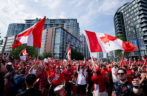 Canada fans march to B.C. Place stadium before the World Cup Group B soccer match between Switzerland and Canada in Vancouver, British Columbia, Wednesday, June 24, 2026.