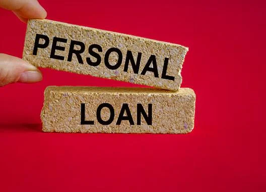 Hand placing a personal loan block