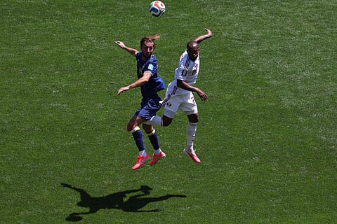 Bosnia's Ivan Sunjic (14), left, and Qatar's Ahmed Fathy (20) jump for the ball during the World Cup Group B soccer match between Bosnia and Qatar in Seattle, Wednesday, June 24, 2026.