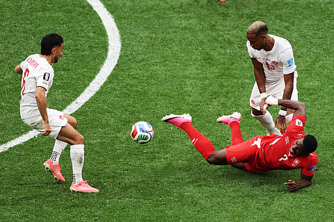Switzerland's Breel Embolo (7) falls after contact with Canada's Derek Cornelius (13) during the World Cup Group B soccer match between Switzerland and Canada in Vancouver, British Columbia, Wednesday, June 24, 2026.